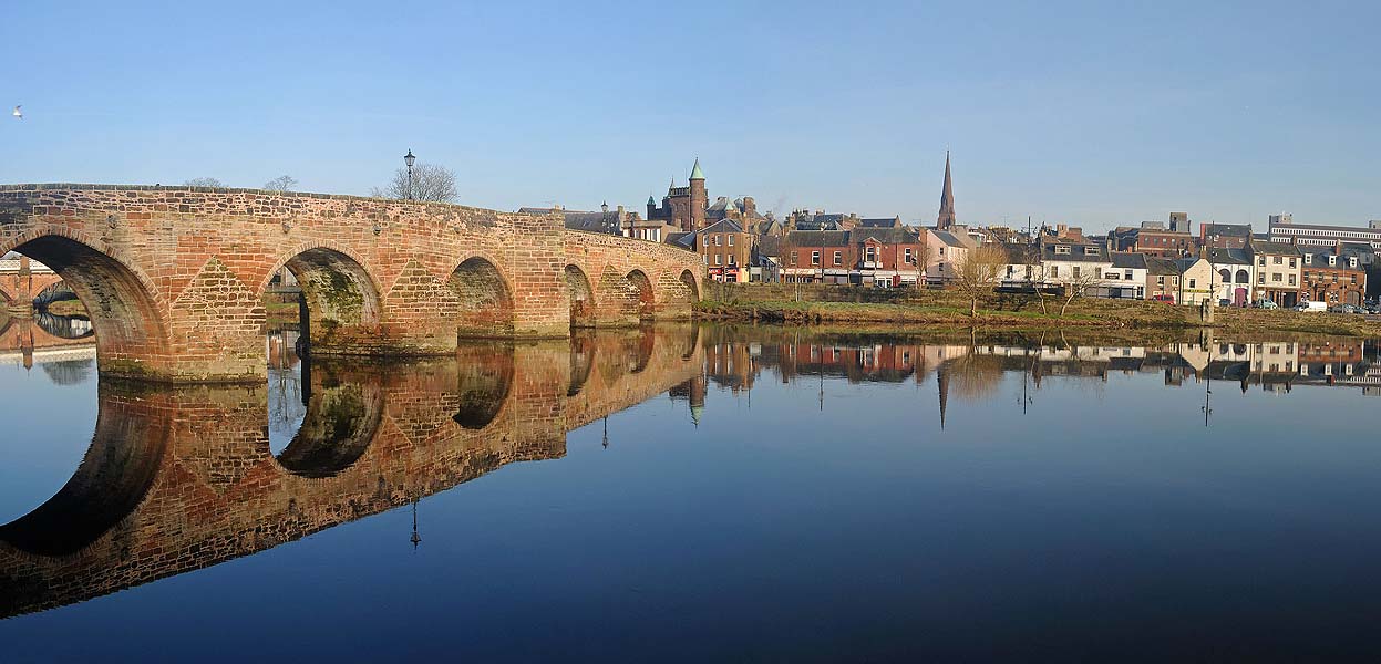 old arched bridge over river